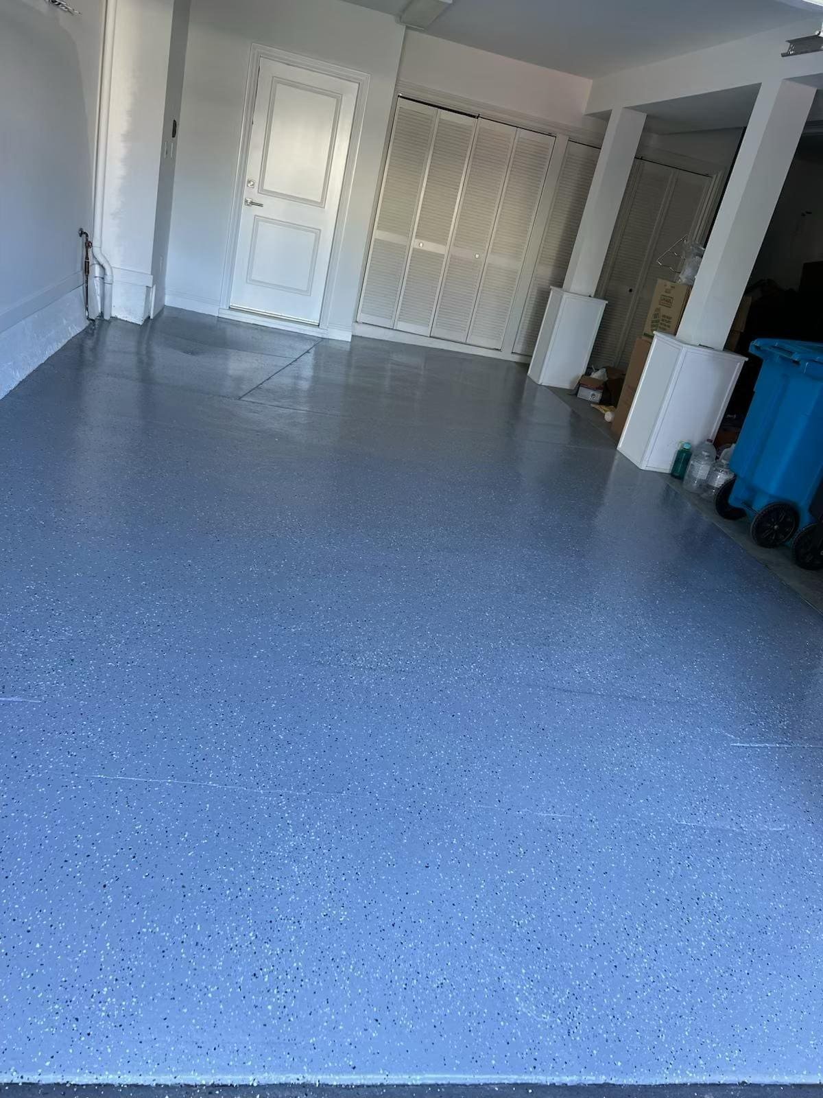 Freshly painted blue epoxy garage floor by Santi Painting Inc.