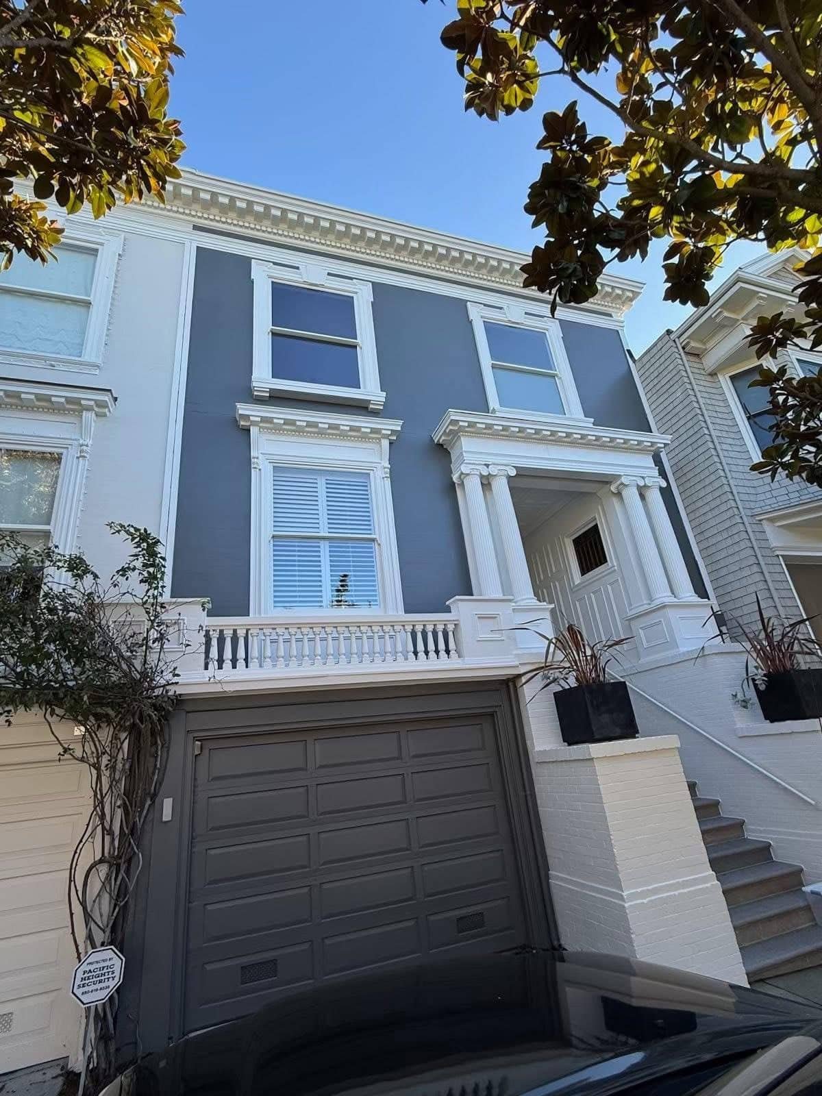 Beautifully painted blue house with white trim and large windows.