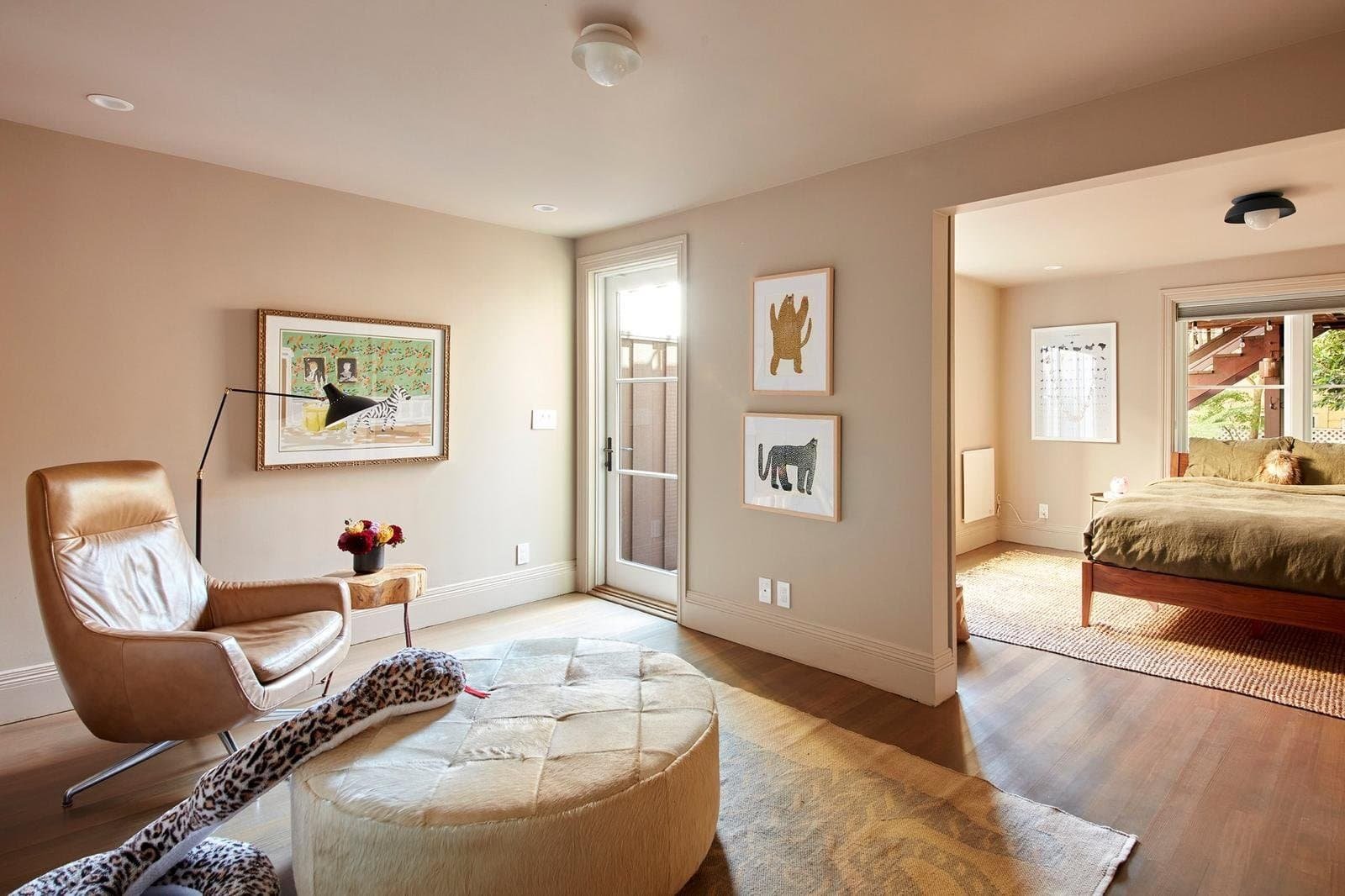 Spacious living room with large window and cozy seating area.