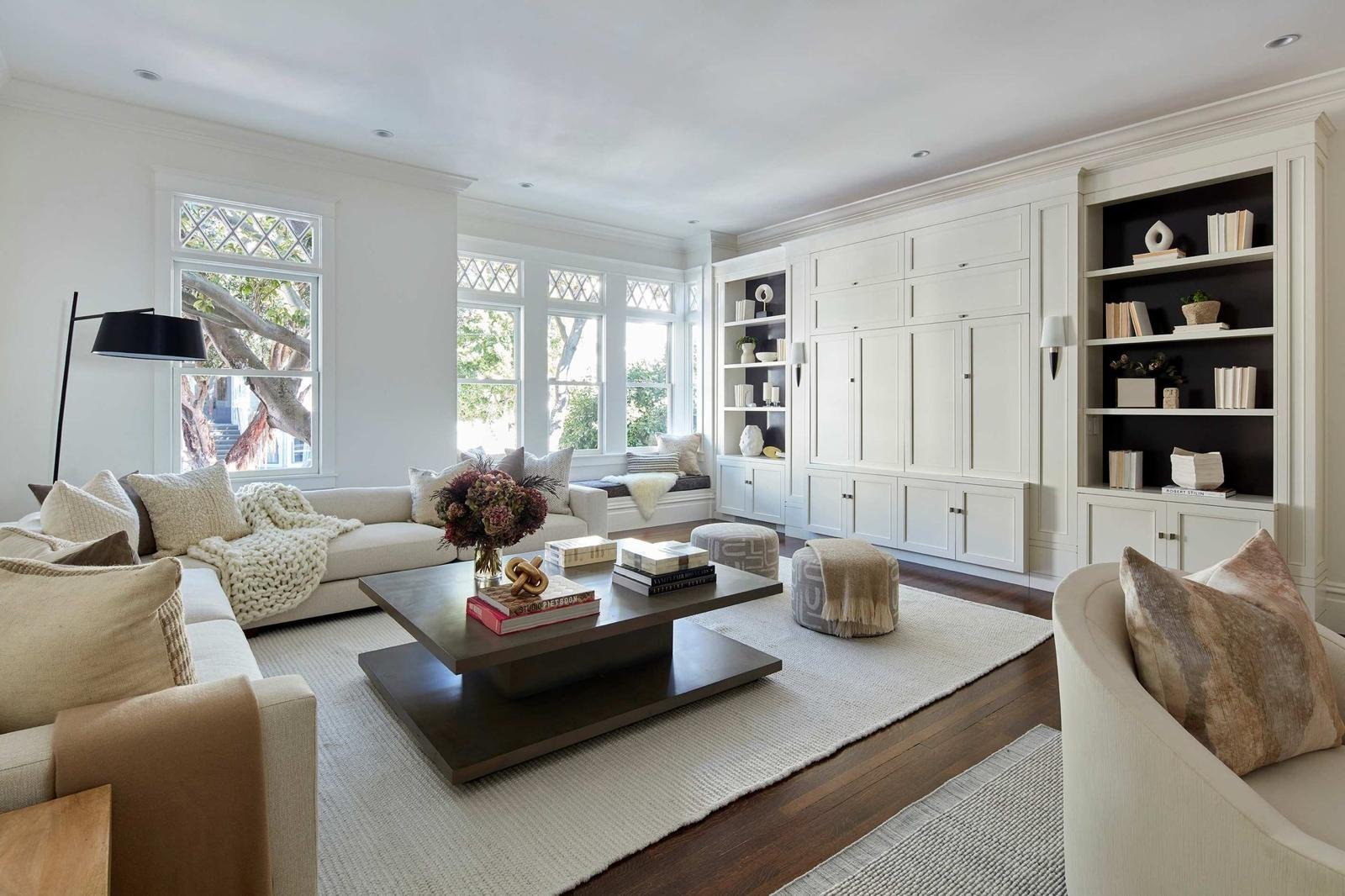 Bright and spacious living room with white walls and large windows.