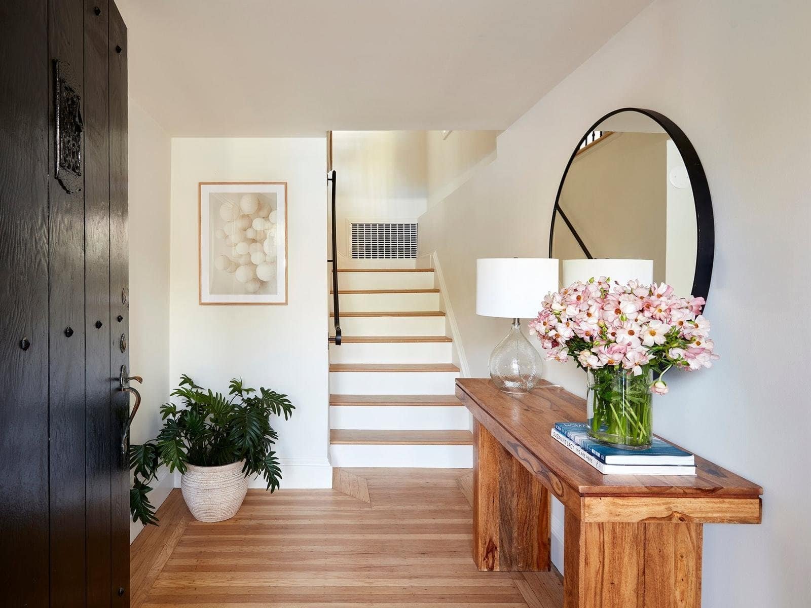 Bright and welcoming home entryway with wooden accents and decor.