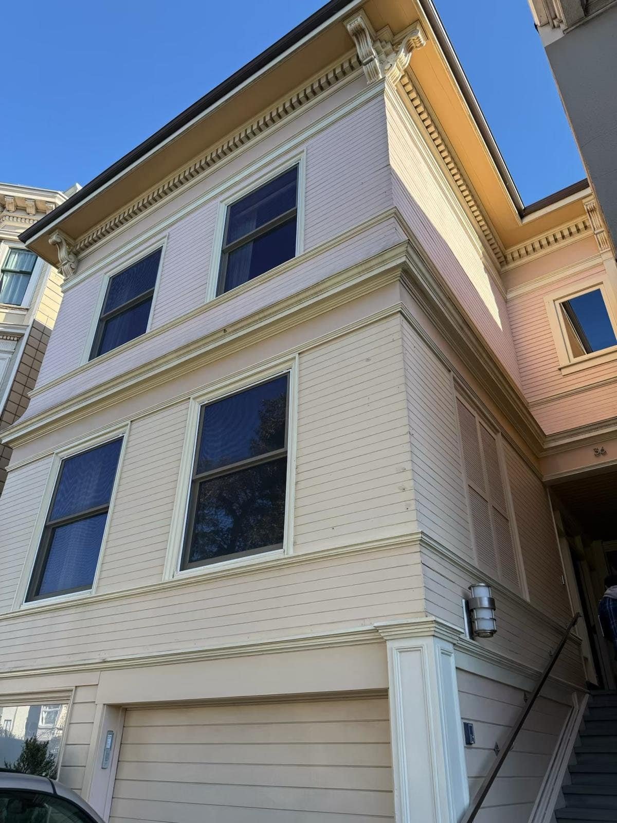 Exterior house painting by Santi Painting Inc. showcasing a clean, freshly painted white home with a.